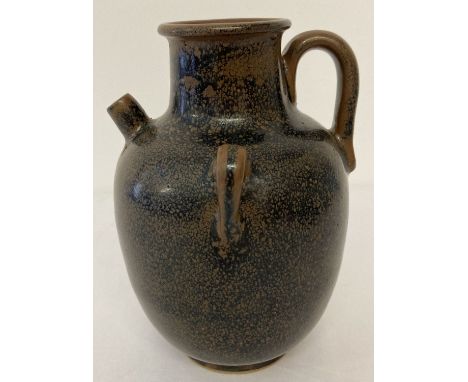 A brown ceramic 3 handled, small spouted urn with black speckled glaze.  Approx. 18cm tall.