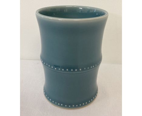 A blue glazed ceramic brush pot in the form of bamboo. Signature to underside. Approx. 11cm tall x 7.5cm diameter.