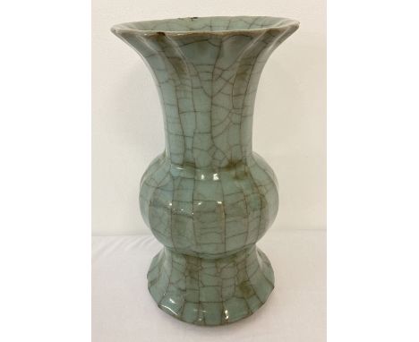 A pale green crackle glaze vase with scalloped rim. slight damage to rim. Approx. 25cm tall.