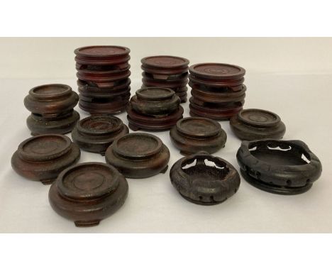 A collection of 22 wooden display stands for mounting ceramic vases etc.  Largest approx. 7.5cm diameter, smaller approx. 6.5