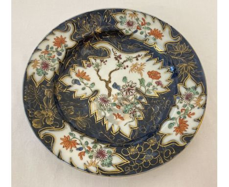 A Chinese porcelain plate with blue glaze ground and floral panel design. Hand painted and gilt detail. Underside features ha