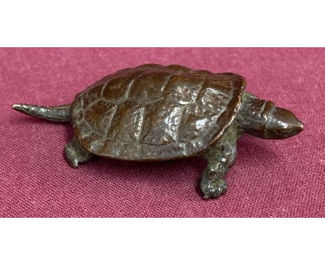 A small Chinese bronze figure of a turtle, signed to underside.  Approx. 1.5cm tall x 6cm long.