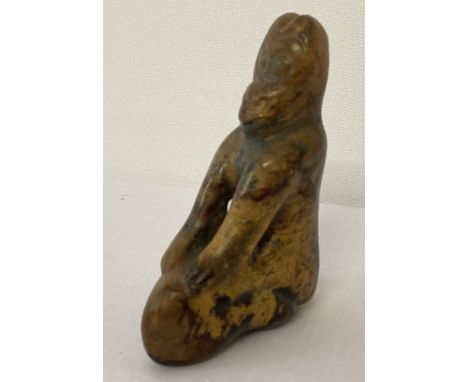 A piece of carved jade in the form of a kneeling figure.  Approx. 10cm tall x 7cm wide.