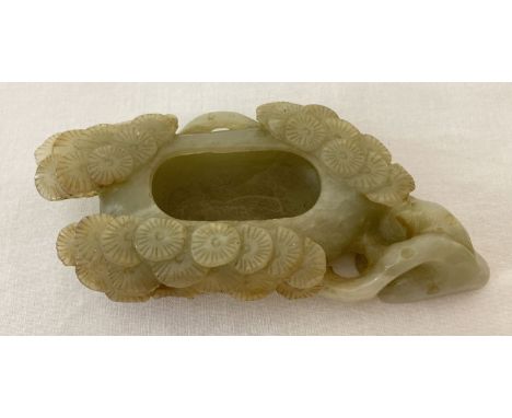 A carved jade brush washer with cherry blossom detail.  Approx. 12cm long.