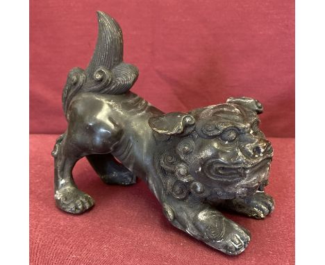 A  hollow bronze figurine of a foo dog.  Each approx. 13.5cm tall x 16cm long.