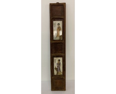 A slim wooden panel with painted ceramic plates featuring figural detail.  Approx. 90cm x 15.5cm.