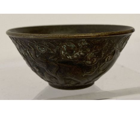 A small Chinese bronze bowl with elephant detail to outer bowl. Signed to underside. Approx. 3cm tall x 6cm diameter.