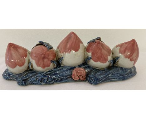 A hand painted ceramic brush rest in the form of 5 peaches.  Approx. 21cm long.