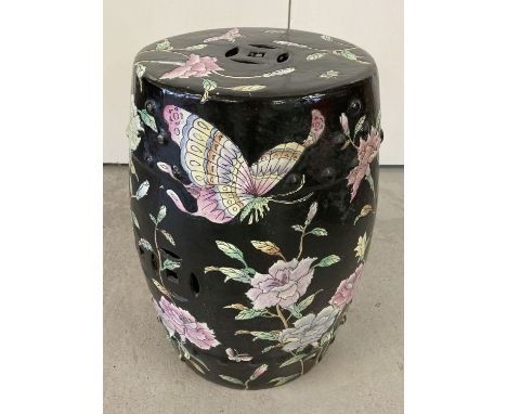 A black glazed Oriental ceramic stool with flower and bird design. Pierced work detail to top and sides. Approx. 48cm tall x 