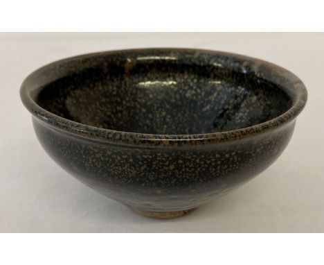 A small ceramic bowl with black hares fur style glaze.  Approx. 6.5cm tall x 13cm diameter.