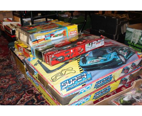 Six children's micro Scalextric and similar, and Thomas the Tank Engine playsets to include The Simpsons Scalextric gift set