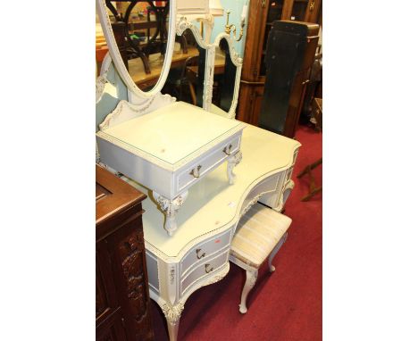 A contemporary French white wood triptych mirror back serpentine kneehole dressing table, having an arrangement of five short