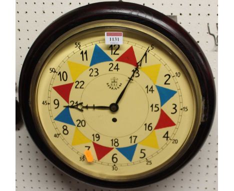 A reproduction circular wall clock, bears RAF painted insignia (with pendulum and key), dia. 38cm