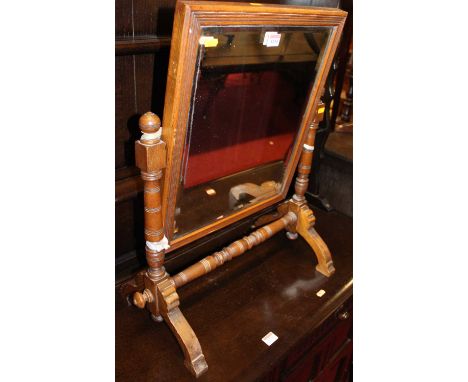 An Aesthetic Movement ash bevelled swing toilet mirror, raised on ring turned stand