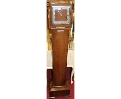 An Art Deco oak grandmother clock, having a striking and chiming movement (lacking pendulum), height 143cm