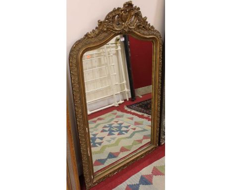 A 19th century French gilt wood and gesso floral decorated arched wall mirror, 145 x 90cm