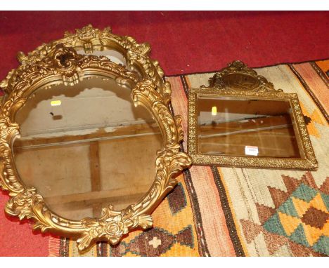 A continental embossed brass wall mirror, 42 x 33cm; together with two gilt composition wall mirrors (3)