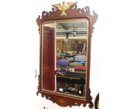 A large early 20th century Chippendale style fret carved mahogany wall mirror, having gilded eagle integral surmount, 109 x 6