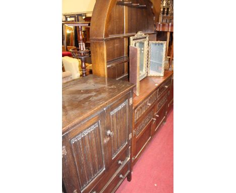 An oak dome top dresser, width 122cm, together with an oak linenfold double door side cupboard with twin long lower drawers, 