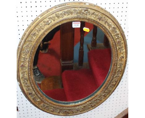 A 19th century gilt wood and floral gesso decorated oval wall mirror, 59 x 51xm
