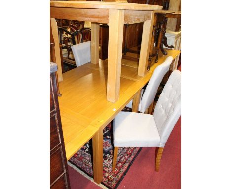 A contemporary joined light oak draw-leaf dining table, max length 155cm, together with a light oak D-end extending dining ta