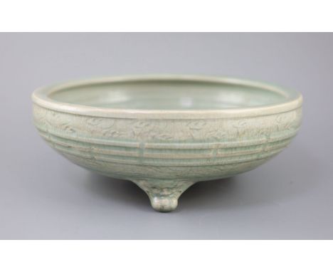 A large Chinese Longquan celadon tripod censer, Ming dynasty, 15th century, unglazed patch to the centre, the exterior moulde
