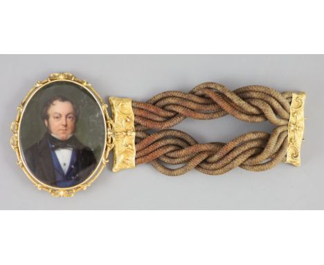 A Victorian oil on ivory portrait miniature of a gentleman, in a gold bracelet frame with original gold mounted entwined hair