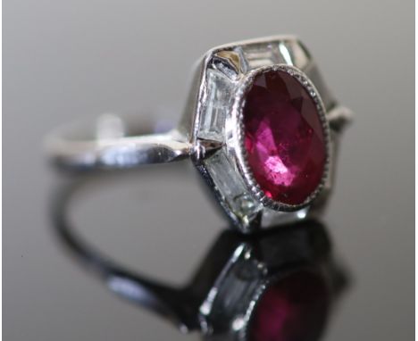 A modern platinum, pinkish/red tourmaline and six stone baguette cut diamond set hexagonal cluster ring, size M, gross 4.2 gr