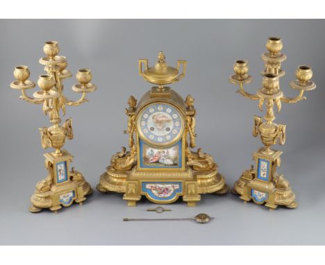 A 19th century Louis XVI style ormolu and Sevres style porcelain clock garniture, the mantel clock of architectural form with