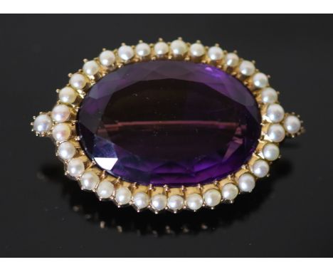 A Victorian style, gold, oval cut amethyst and split pearl cluster set brooch, 48mm, gross 24.3 grams.CONDITION: Amethyst app