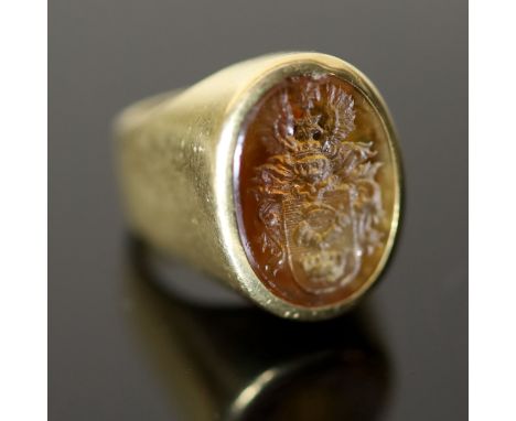 A 20th century continental 18ct gold (stamped 750) and oval citrine? intaglio signet ring, carved with ornate crest, size G, 