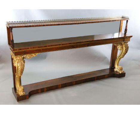 A pair of William IV parcel gilt rosewood console tables, with pierced brass anthemion galleries, single shelf mirrored backs