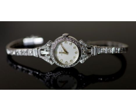 A lady's early 1960's 18ct gold, palladium and diamond set Omega manual wind cocktail watch, on diamond set bracelet, with Ar