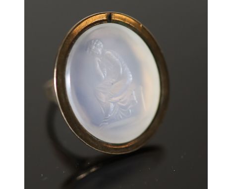 An early 19th century gold and white agate oval intaglio ring, carved with a seated figure, size M, gross 7.7 grams.CONDITION