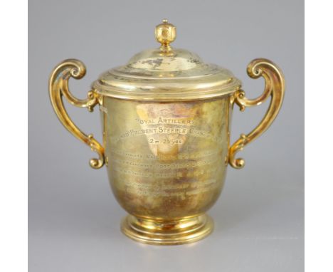 An Edwardian silver gilt-lidded two handled presentation cup and cover, by R &amp; S Garrard and Co. with later engraved insc