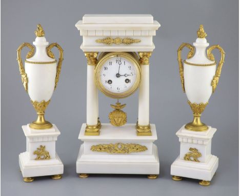 A Louis XVI style ormolu mounted white marble clock garniture, with Portico clock flanked by a pair of urns, clock 14.5in. ur