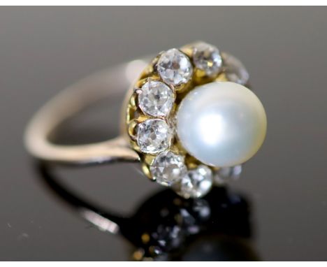 A modern gold, cultured pearl and diamond set circular cluster ring, size M, gross 4.7 grams.CONDITION: Pearl diameter 77mm. 