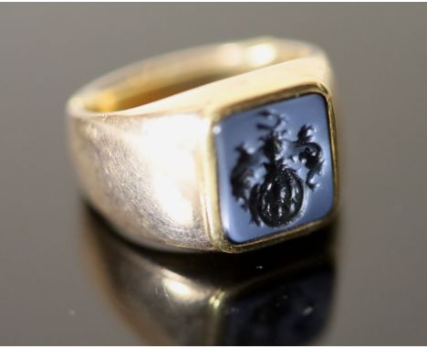 An early 20th century Austro-Hungarian? gold and blue sardonyx set signet ring, the matrix carved with ornate crest, indistin