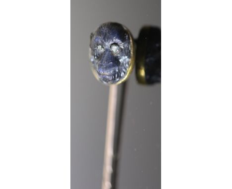 A Victorian gold mounted diamond set labradorite? stick pin, carved as the head of an ape, 78mm, gross 3.8 grams.CONDITION: S