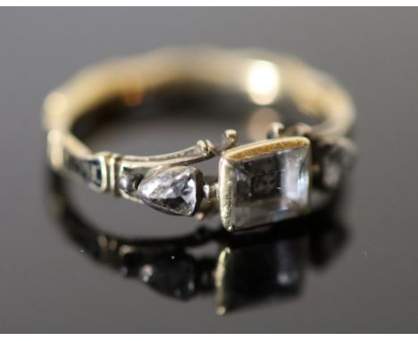 An early George II gold, rock crystal rose cut diamond and black enamel memento mori ring, the central rock crystal with skul