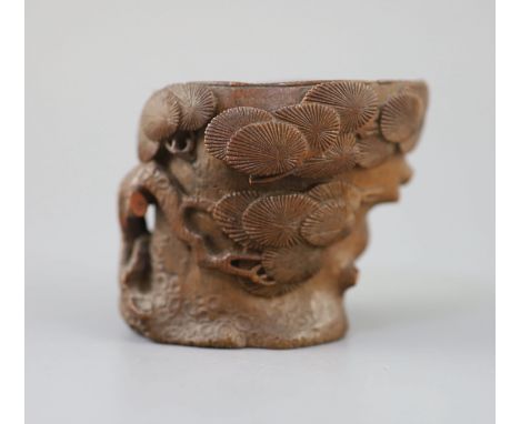 A Chinese bamboo root 'pine' libation cup, 17th/18th century, carved in high relief and openwork as the bough of a pine tree,