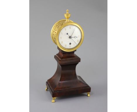 Week's Museum. A Regency gilt brass and mahogany drum case mantel timepiece, with urn final, enamel dial and sweeping second 