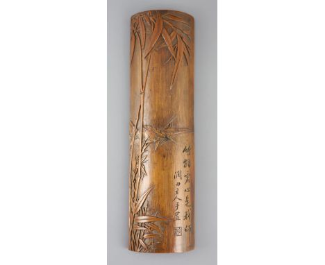 A Chinese bamboo 'bamboo sprig' wrist rest, 18th century, carved in high relief with bamboo and incised with a calligraphic i