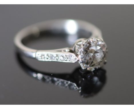 A mid 20th century white gold and single stone diamond ring, with diamond set shoulders, the stone weighing approximately 1.1