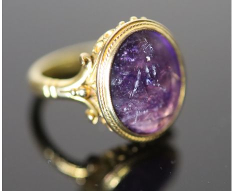 A 19th century style gold ring set with an antique intaglio oval amethyst, carved with a seated figure with a sheep, size P, 