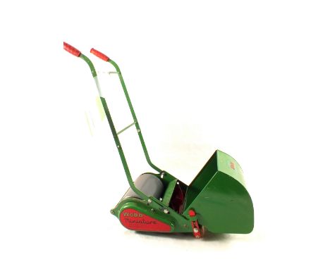 A Webb childs lawn mower with grass box and leaflet