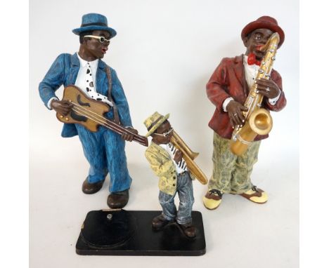 TWO RESIN JAZZ MUSICIAN FIGURES
one playing saxophone, the other a guitar, both approximately 40cm high, and a smaller exampl