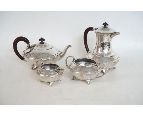 FOUR PIECE BRITANNIA METAL TEA SET comprising a squat tea pot, hot water jug, twin handled sugar bowl and a milk jug, all wit