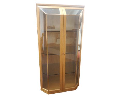 HULSTA LIGHT OAK DISPLAY CABINET
with a pair of shaped glazed doors opening to reveal an illuminated and shelved interior, st