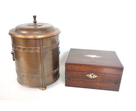 CIRCULAR COPPER WASTE PAPER BIN
the removable lid above a body with Greek key decoration and side carrying handles, standing 